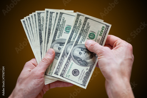 фотографія holding money dollars