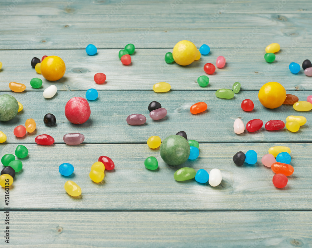 Candies lying over the wooden surface