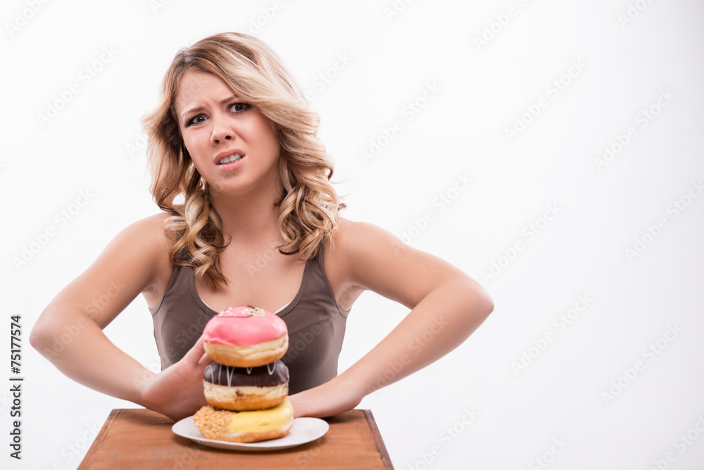 Young attractive woman with doughnuts isolated on white backgrou Young attractive woman with doughnuts isolated on white backgrou