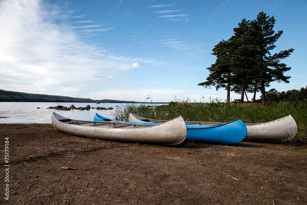 Canoes ashore by the lake Canoes ashore by the lake