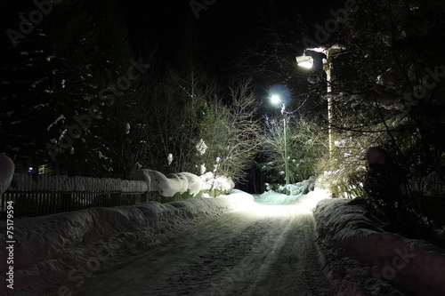 Lights illuminate the road in the village