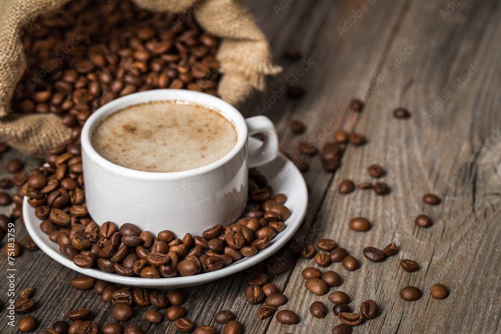 Cup of coffee on wooden table.