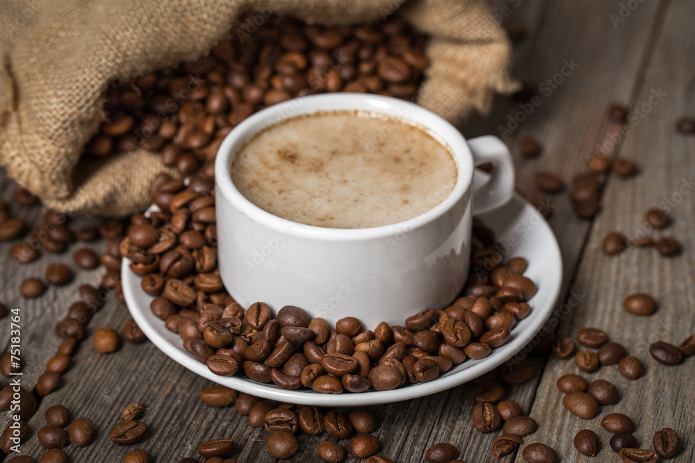 White coffee cup with opened bag. Mug standing on wooden table. White coffee cup with opened bag. Mug standing on wooden table.