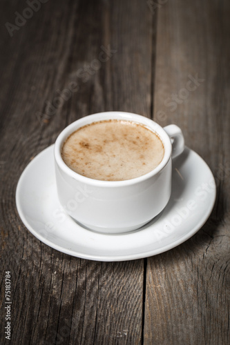 White coffee mug with tasty latte on wooden surface