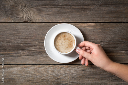 Woman holding warm mug with fresh coffee