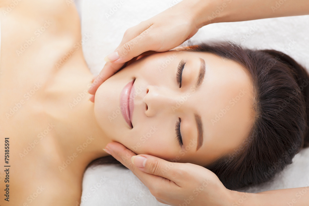 massage of face for woman in spa salon