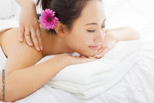 young woman in spa salon getting massage