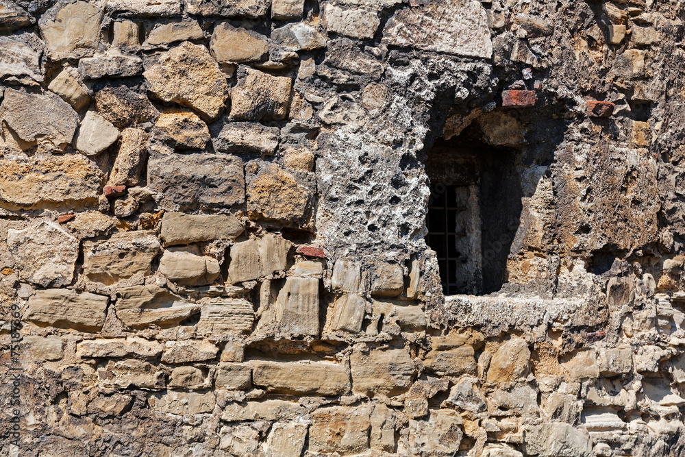 old stone wall with window