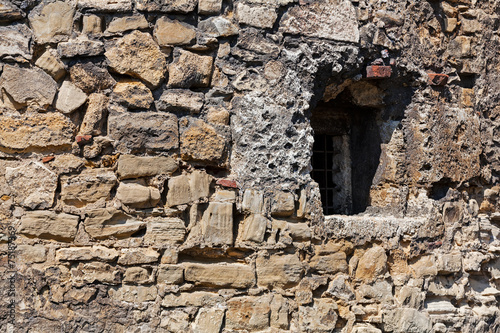 old stone wall with window