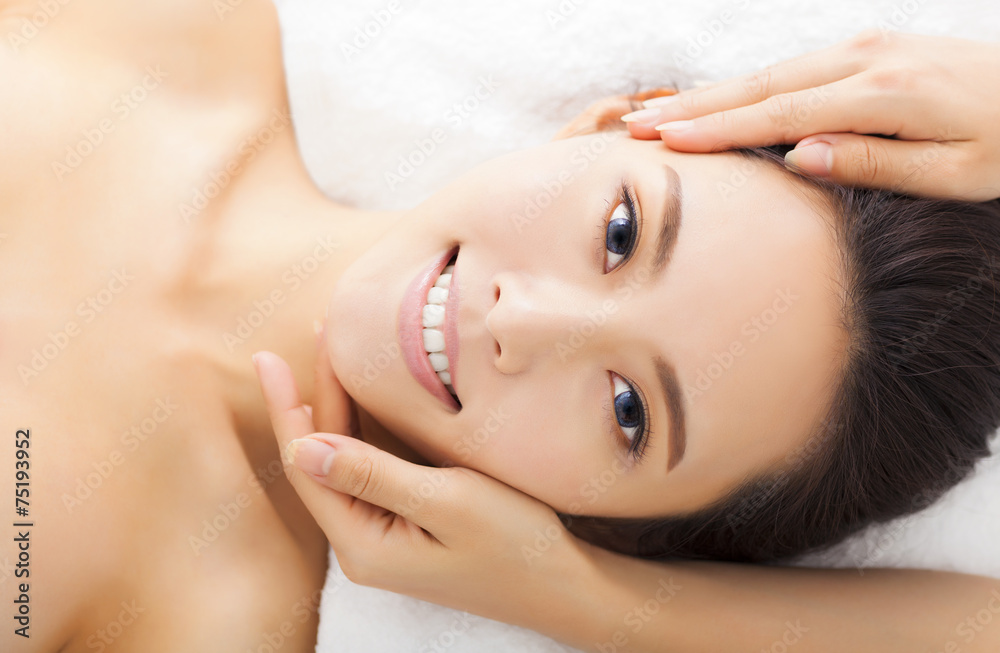 massage of face for woman in spa salon