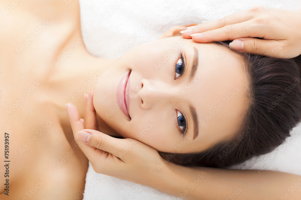 massage of face for woman in spa salon