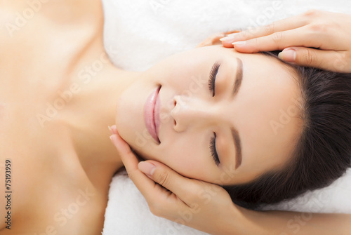 massage of face for woman in spa salon