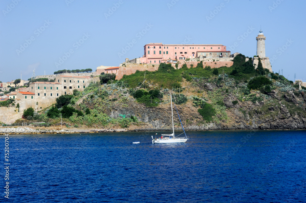 Sailboat cruising in front of Portoferraio on Elba island