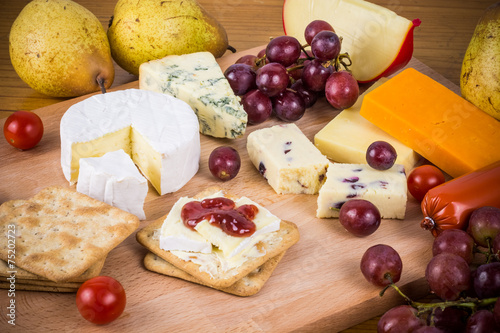 Delicious cheese platter with grapes and crackers