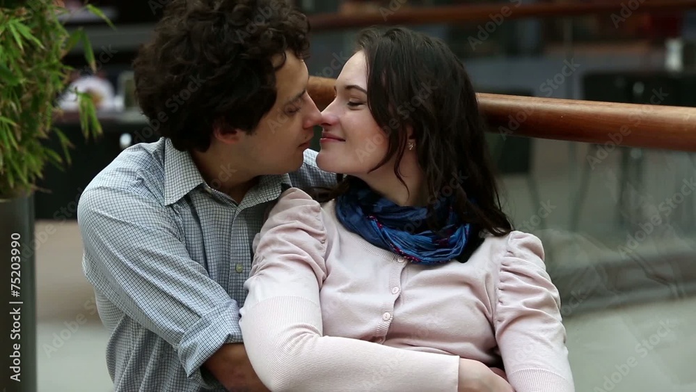 Love couple in shopping center kissing after shopping Love couple in shopping center kissing after shopping