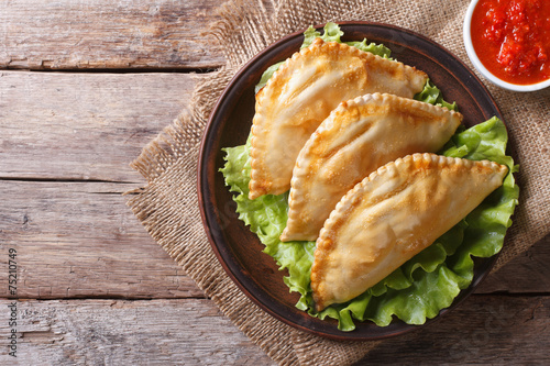 Traditional empanadas and sauce closeup. horizontal top view photo