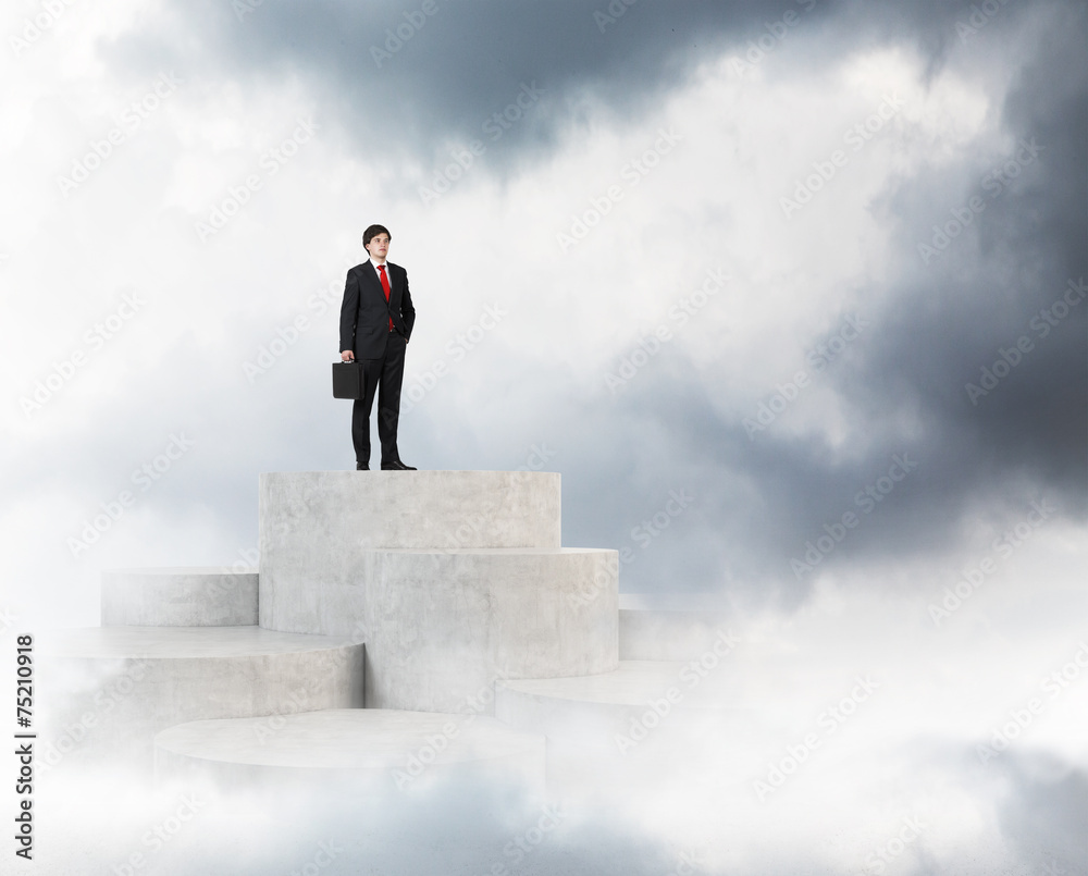 businessman standing on peak stairs businessman standing on peak stairs