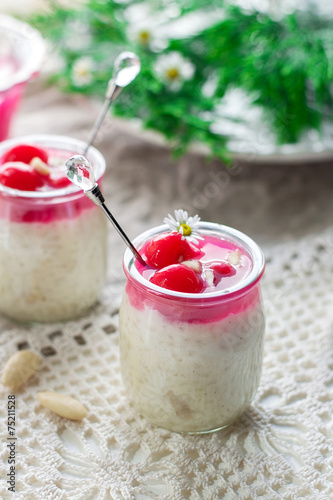 Rice pudding with almonds, whipped cream and cherry sauce