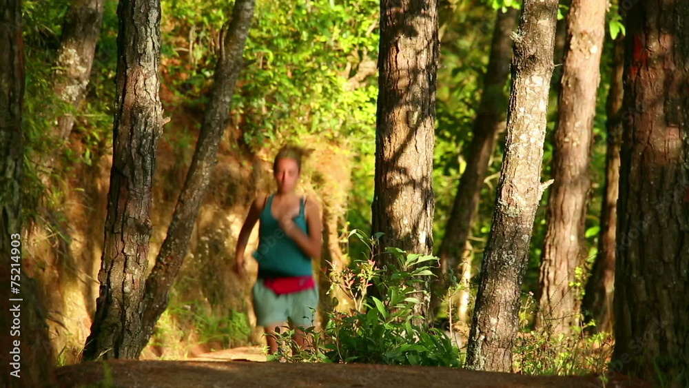 Sexy girl running along narrow footpath in forest Sexy girl running along narrow footpath in forest