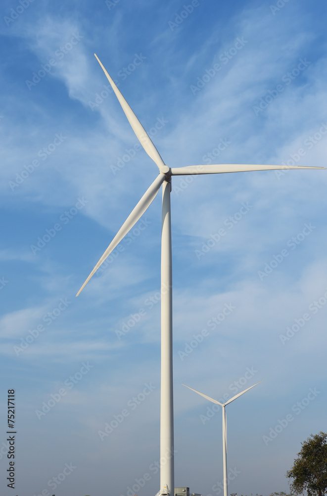 wind turbine against cloudy blue sky background wind turbine against cloudy blue sky background