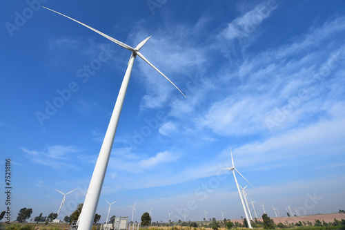 wind turbine against cloudy blue sky background