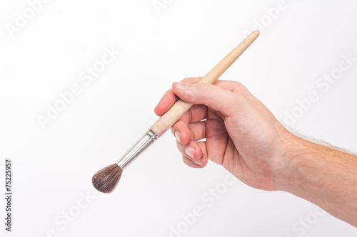 isolated man's hand with a brush