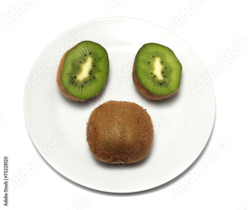 ripe kiwi on a white plate