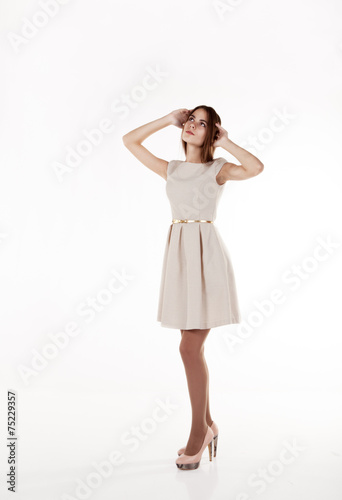 young beautiful girl in a bright dress looking up © Radnatt