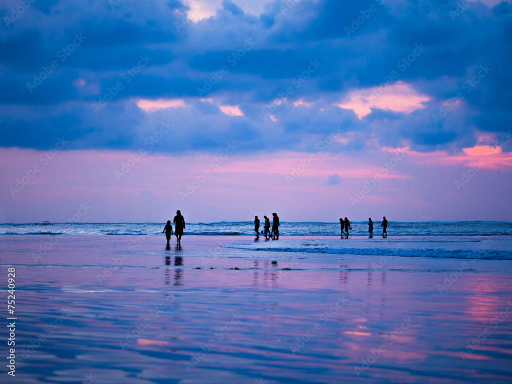 Silhouettes of people at sunset on the beach of Kuta Bali I