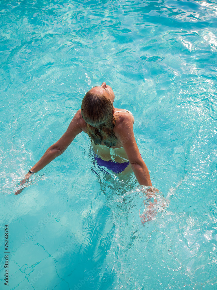 Top view of a woman in bikini at the pool
