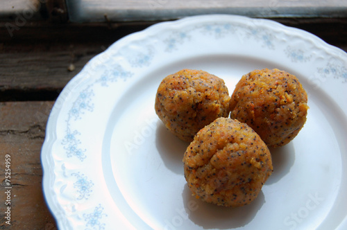 carrot truffles with poppy seeds on a dessert plate