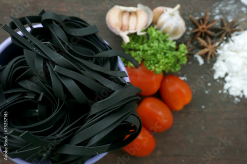 Pasta with ingredients like flour, tomato, garlic and pepper photo