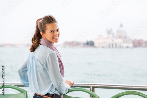 Smiling young woman travel by venice water bus
