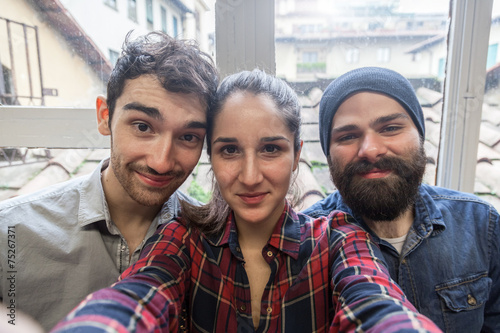 Three young friends take a Selfie from the office