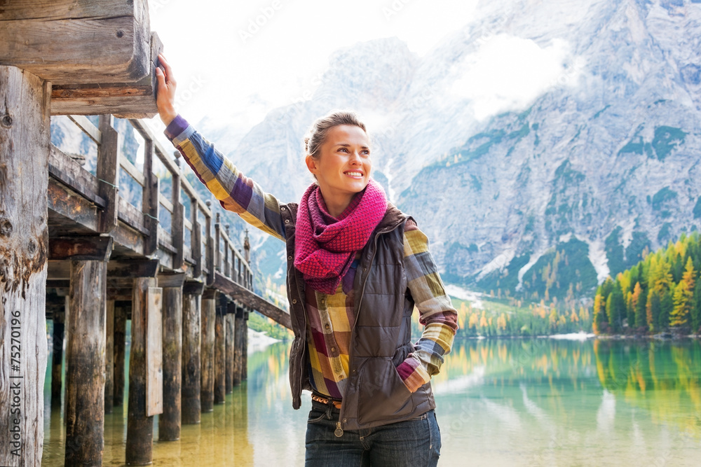 Happy young woman on lake braies in south tyrol, italy Happy young woman on lake braies in south tyrol, italy