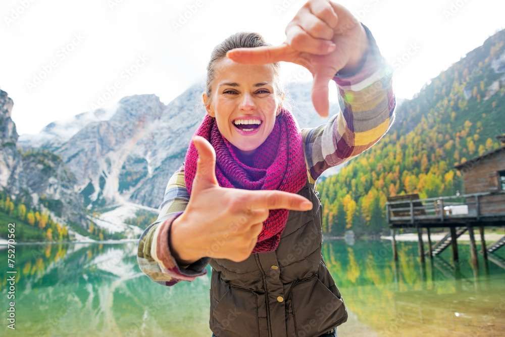 Portrait of smiling young woman on lake braies in south tyrol