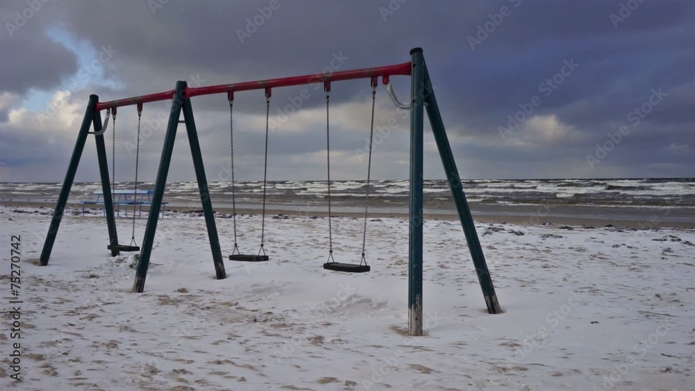 Swing on the beach in a storm in December Swing on the beach in a storm in December