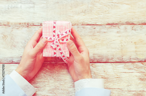 male hand holding a gift