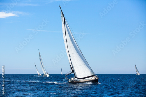 Group of sail yachts in regatta in open the Sea. © De Visu