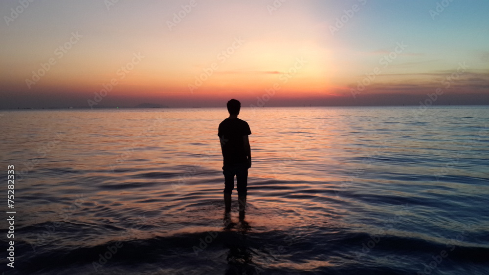 A man standing on water looking out to the ocean