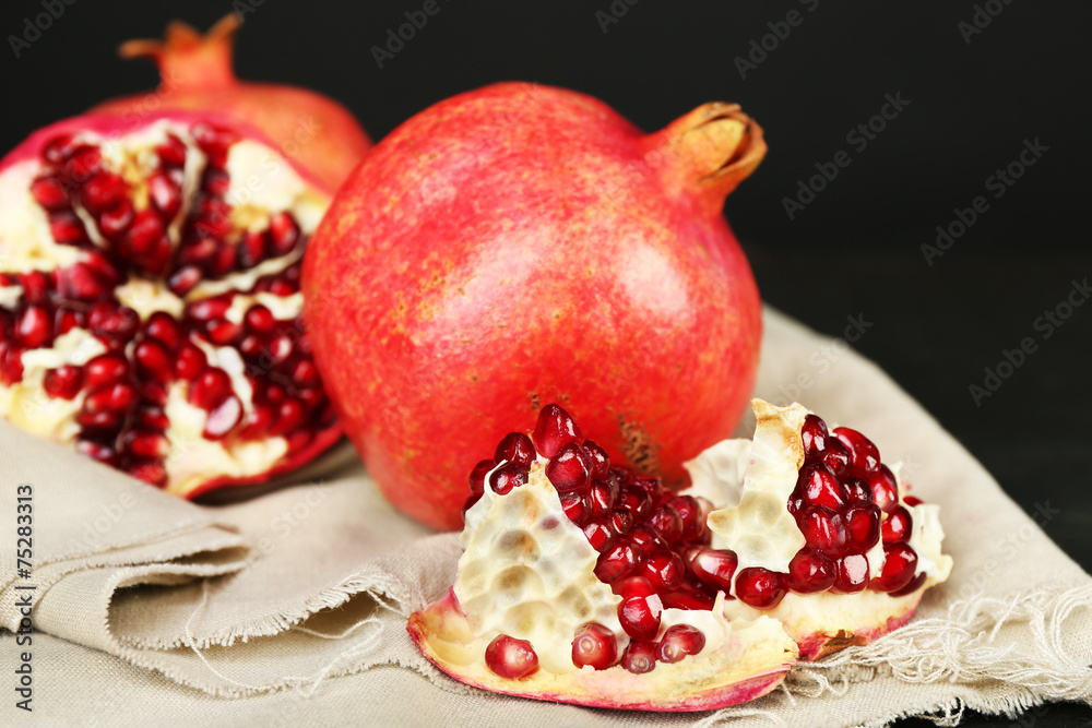Juicy ripe pomegranates on dark background Juicy ripe pomegranates on dark background