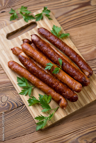 Smoked sausages with parsley, high angle view, vertical shot