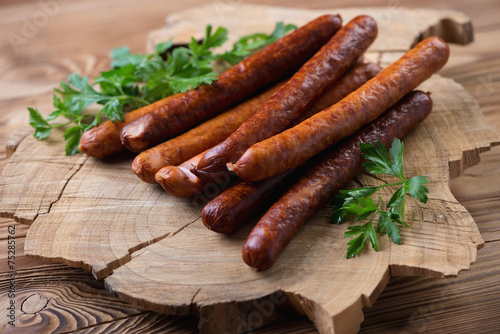Sausages with parsley over rustic wooden background