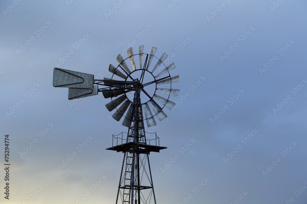 American windmill and a sky with different clouds. American windmill and a sky with different clouds.