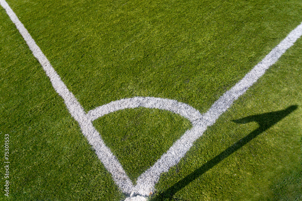 Closeup photo of corner marking on grass soccer field