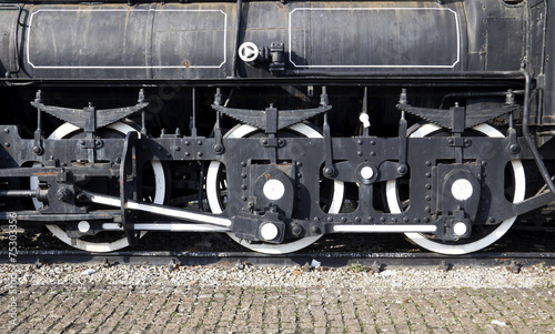 Grunge old steam locomotive wheel and rods photo