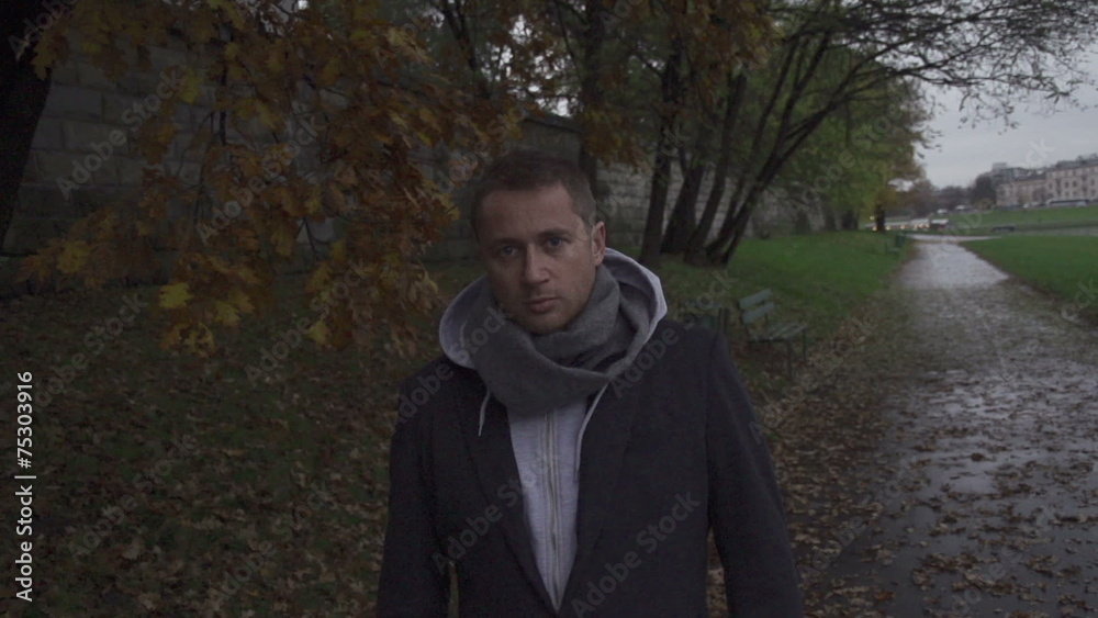 Pensive, man looking to the camera, steadycam shot, slow motion Pensive, man looking to the camera, steadycam shot, slow motion