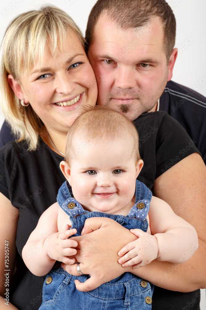 Loving mother and father embracing her baby girl Loving mother and father embracing her baby girl