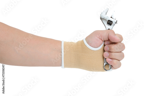 Man hand with wrist-support protection holding wrench on white b