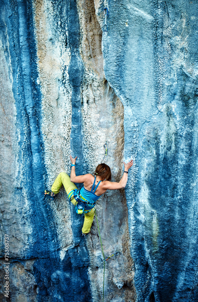 Rock climber climbing up a cliff Rock climber climbing up a cliff